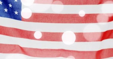 Animation of light spots over flag of usa. Patriotism and celebration concept digitally generated video.