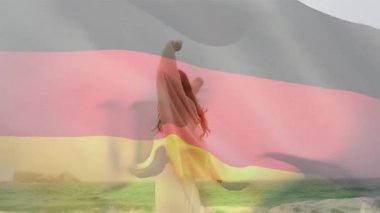 Animation of flag of deutschland over caucasian woman at beach. National flags, patriotism and holiday concept digitally generated video.