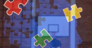 Animation of puzzle pieces over diverse schoolchildren and teacher using tablet. autism awareness month and celebration concept digitally generated video.