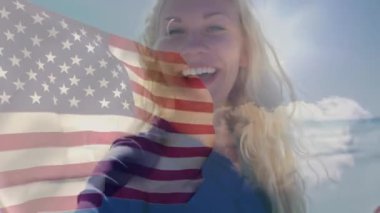 Animation of happy caucasian woman over flag of usa. American patriotism and nation diversity concept digitally generated video.