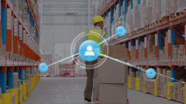 Animation of networks of connection with people icons over caucasian man working in warehouse. Global shipping, business, connections, networks and data processing concept digitally generated video.