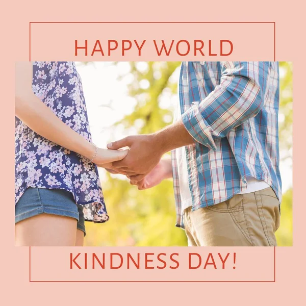 Composition of happy world kindness day text and photo of diverse couple holding hands. World kindness day and love concept.