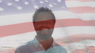 Animation of happy african american man over flag of usa. American patriotism and nation diversity concept digitally generated video.