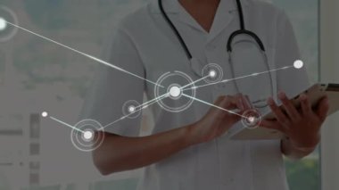 Animation of network of connections over caucasian male doctor. Global connections digital interface technology and networking concept digitally generated video.