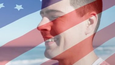 Animation of flag of usa over happy caucasian man. American patriotism and nation diversity concept digitally generated video.