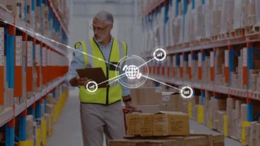 Animation of networks of connection with icons over caucasian man working in warehouse. Global shipping, business, connections, networks and data processing concept digitally generated video.