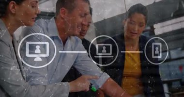 Animation of digital icons over diverse colleagues discussing over documents at office. Global networking and business technology concept