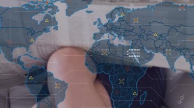 Animation of world map over woman reading newspaper. Global business, finances, digital interface and connections concept digitally generated video.