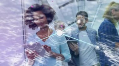 Animation of data processing and network of connections over diverse business people using tablets. Global business, computing and digital interface concept digitally generated video.