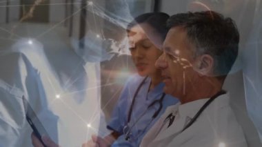Animation of network of connections over two diverse doctors. Global medicine, technology, data processing and digital interface concept digitally generated video.