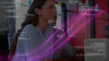 Animation of digital programming code loop over multiracial smiling colleagues talking in office. Digital composite, multiple exposure, database, business, teamwork and technology concept.