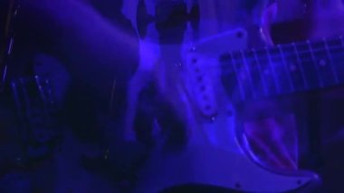 Animation of blue shapes over musician playing guitar. Music, party, clubbing and disco concept digitally generated video.