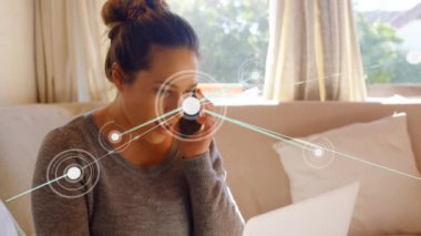 Animation of network of connections over caucasian woman talking on smartphone at home. Global networking and business technology concept