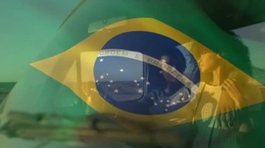 Animation of brazilian flag waving over romantic african american couple traveling in pick-up truck. Road trip, enjoyment, love, togetherness, vacation, travel, patriotism and identity concept.