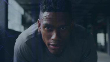 Animation of interference and data processing over resting african american male athlete training. Fitness, sport, health and digital interface concept digitally generated video.