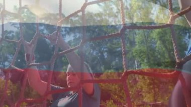 Animation of flag of russina over diverse man and woman during obstacle race training. national sports, activity and patriotism concept digitally generated video.