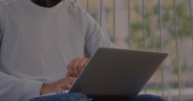 Animation of data processing over biracial man using laptop. Global technology, computing and digital interface concept digitally generated video.