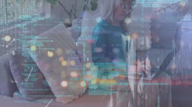 Animation of data processing over caucasian woman using laptop. Lifestyle and digital interface concept digitally generated video.