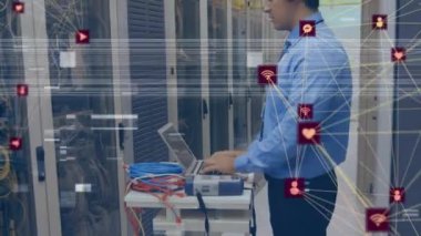 Animation of network of connections with icons over caucasian engineer by computer servers. Global computing, data processing and networks concept digitally generated video.