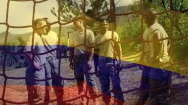 Animation of flag of columbia over diverse male soldiers during training. army, defense and patriotism concept digitally generated video.