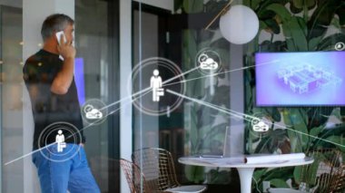Animation of network of connections icons over caucasian businessman using smartphone. Global business, technology, computing, data processing and networks concept digitally generated video.