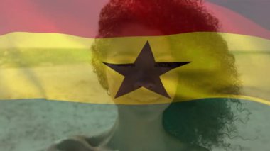 Animation of ghana flag waving over portrait of smiling african american woman enjoying at beach. Digital composite, multiple exposure, vacation, patriotism and identity concept.