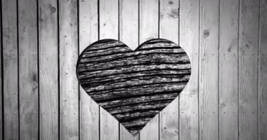 Animation of heart shape cut in wood, with moving wood grain pattern, black and white. Nature and love, retro monochrome abstract background concept digitally generated video.