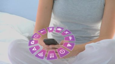 Animation of travel icons and caucasian woman using smartphone. Global travel, technology, digital interface and data processing concept digitally generated video.