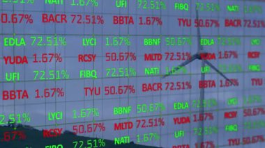 Animation of financial data processing over wind turbine against blue sky. Communication, energy and power generation, business, data and digital interface concept digitally generated video.