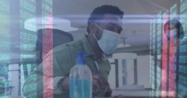 Animation of qr code scanner and data processing african american man using hand sanitizer at office. Global economy and business technology concept