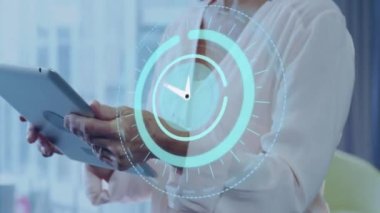 Animation of scope scanning and clock over biracial businesswoman using tablet. global business, data processing and technology concept digitally generated video.