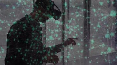 Animation of network of connections with icons over caucasian businessman using vr headset. Global technology, connections and digital interface concept digitally generated video.