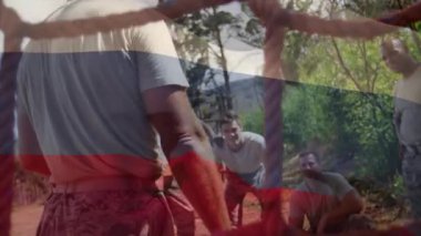 Animation of flag of columbia over african american man during obstacle race training. national sports, activity and patriotism concept digitally generated video.