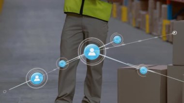 Animation of network of people icons over caucasian man working in warehouse writing on clipboard. Global communication network, business and digital interface concept digitally generated video.