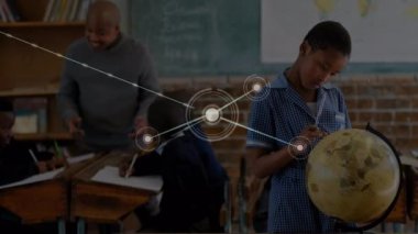 Animation of network of connections with icons over african american boy with globe at school. learning geography, education, connections and technology concept digitally generated video.
