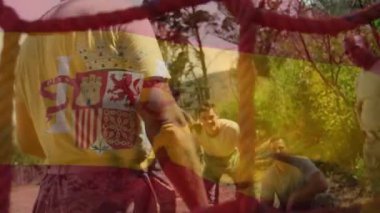 Animation of flag of spain over diverse male soldiers during training. army, defense and patriotism concept digitally generated video.
