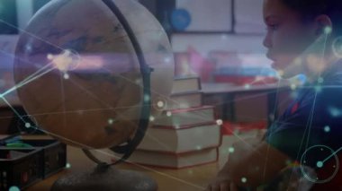 Animation of network of connections with icons over african american boy with globe at school. learning geography, education, connections and technology concept digitally generated video.