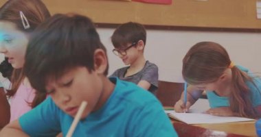 Animation of glowing light over diverse school children in classroom. Education, learning and development concept digitally generated video.