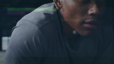 Animation of interference and data processing over resting african american male athlete training. Fitness, sport, health and digital interface concept digitally generated video.