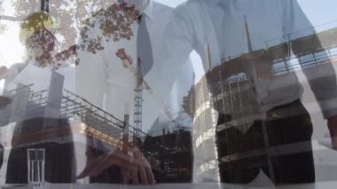 Animation of diverse business people over building site. global business, computing and digital interface concept digitally generated video.