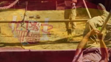 Animation of flag of spain over diverse male soldiers during training. army, defense and patriotism concept digitally generated video.