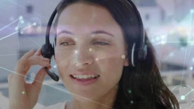 Animation of network of connections over caucasian businesswoman in office. Global business and digital interface concept digitally generated video.