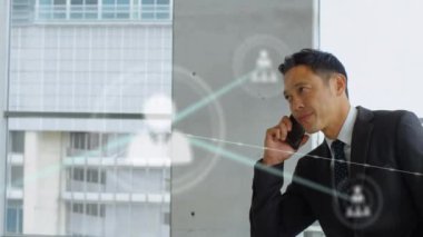 Animation of network of connections over biracial businessman using smartphone. Global business and digital interface concept digitally generated video.