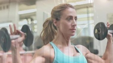 Animation of statistics and data processing over fit caucasian woman exercising. Sports, exercise, fitness and data processing concept digitally generated video.