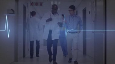 Animation of heart rate monitor over two diverse male doctors discussing at hospital. Medical healthcare and technology concept