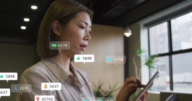 Animation of network of connections with icons over caucasian businessman using smartphone. Global digital interface technology and networking concept digitally generated video.