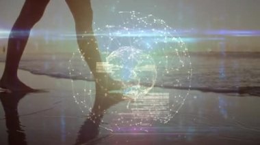 Animation of data processing over caucasian woman walking at beach. Global sport and digital interface concept digitally generated video.