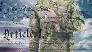 Animation of text and sky with clouds over caucasian male soldier and flag of usa. Patriotism, politics and digital interface concept digitally generated video.