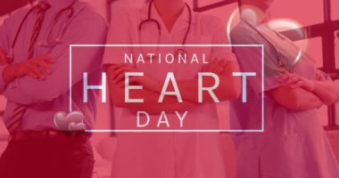 Animation of national heart day text over happy caucasian doctors. heart month and celebration concept digitally generated video.