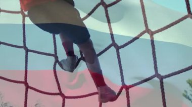 Animation of flag of russia over caucasian boy during obstacle race training. national sports, activity and patriotism concept digitally generated video.
